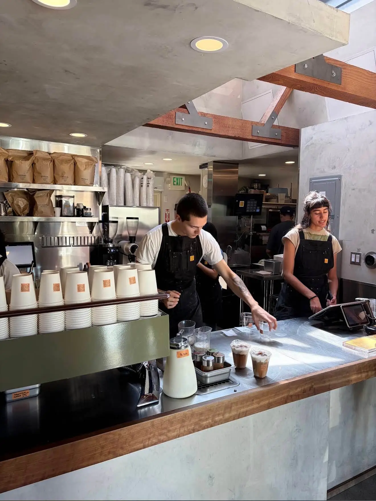 Coffee bar and espresso setup behind the counter at Community Goods