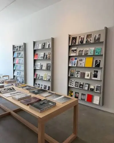 Wooden shelves with pantry goods and records at Community Goods