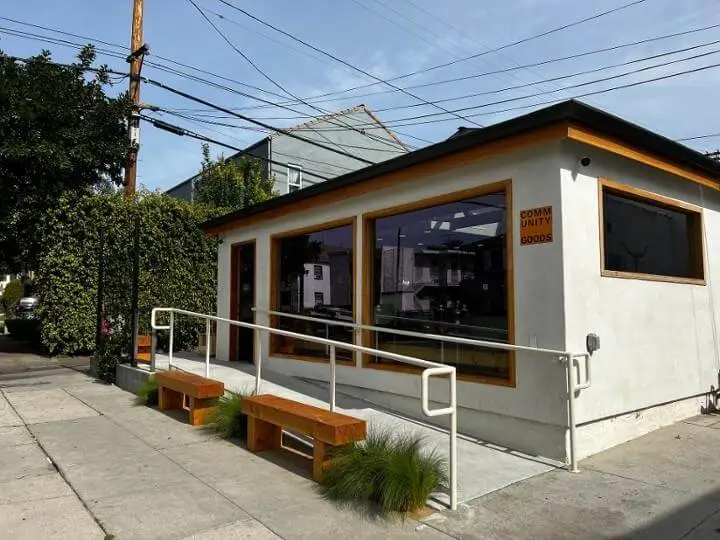 Quiet sidewalk outside Community Goods on a weekday morning